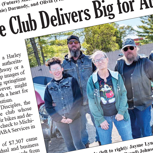 A snapshot of a newspaper showing some text an a picture of four people from a motorcycle club